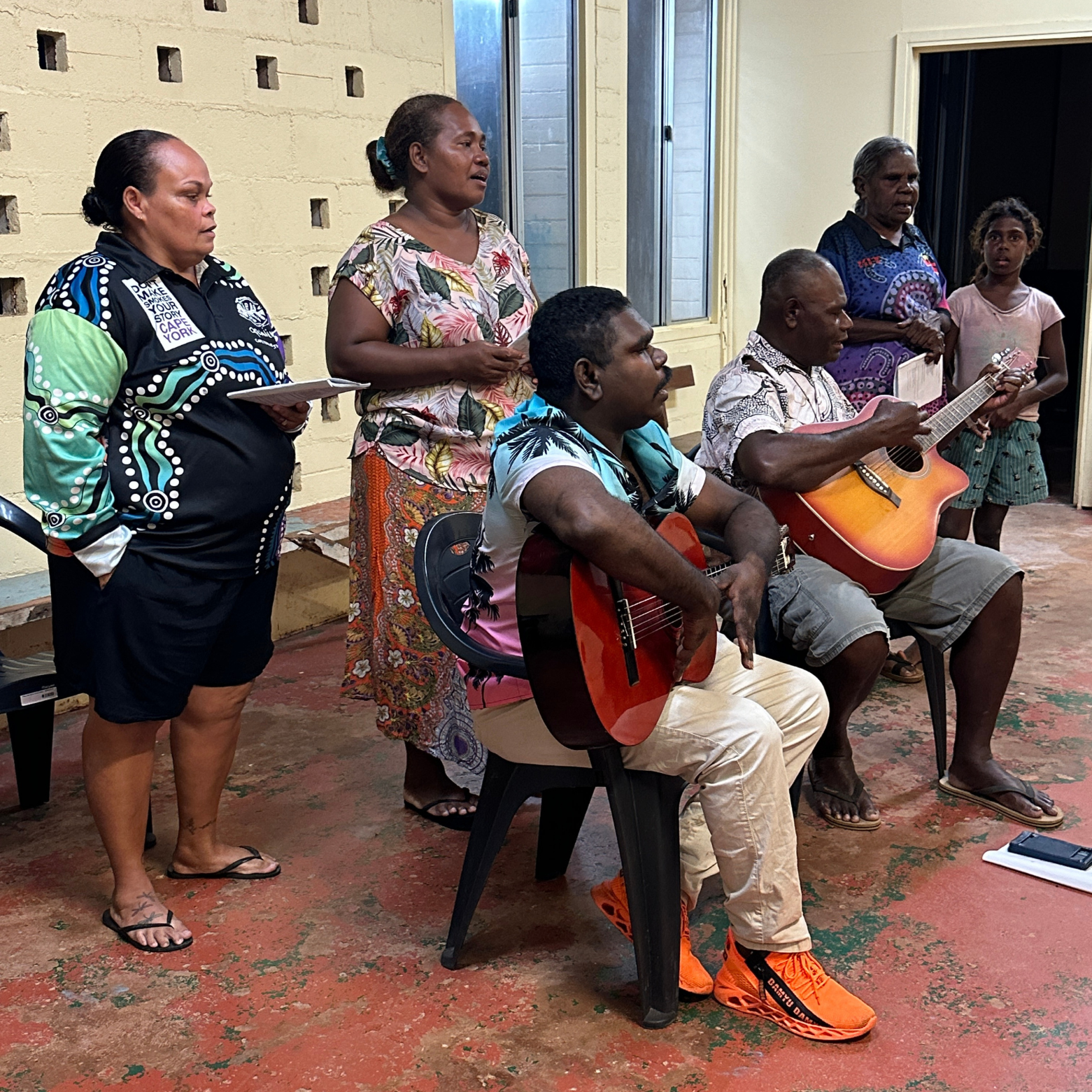 Simon and musicians sit together waiting to play at the service.