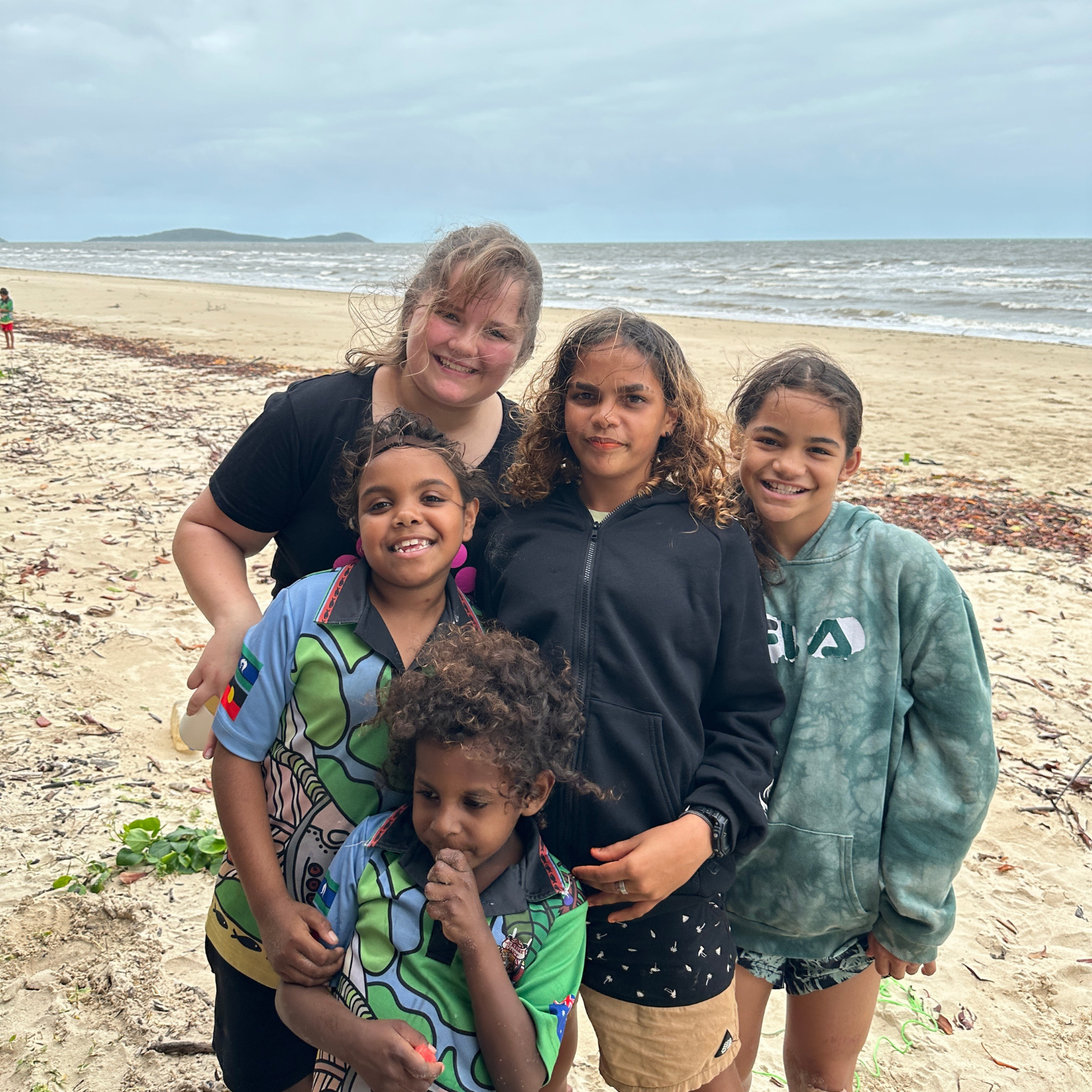 Group pose on the beach during the SONG Program