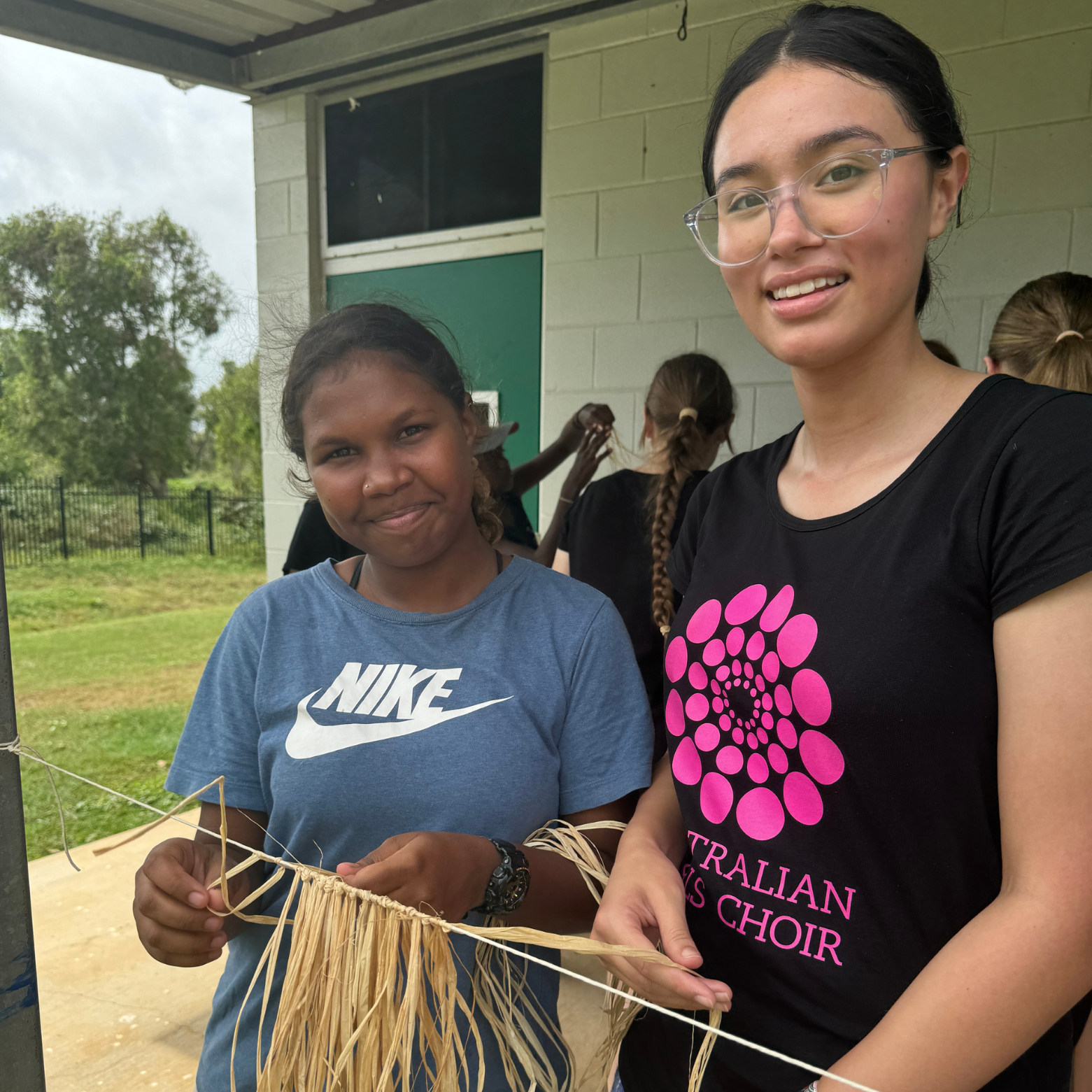 Girls make a jaji (grass skirt) together in Lockhart River