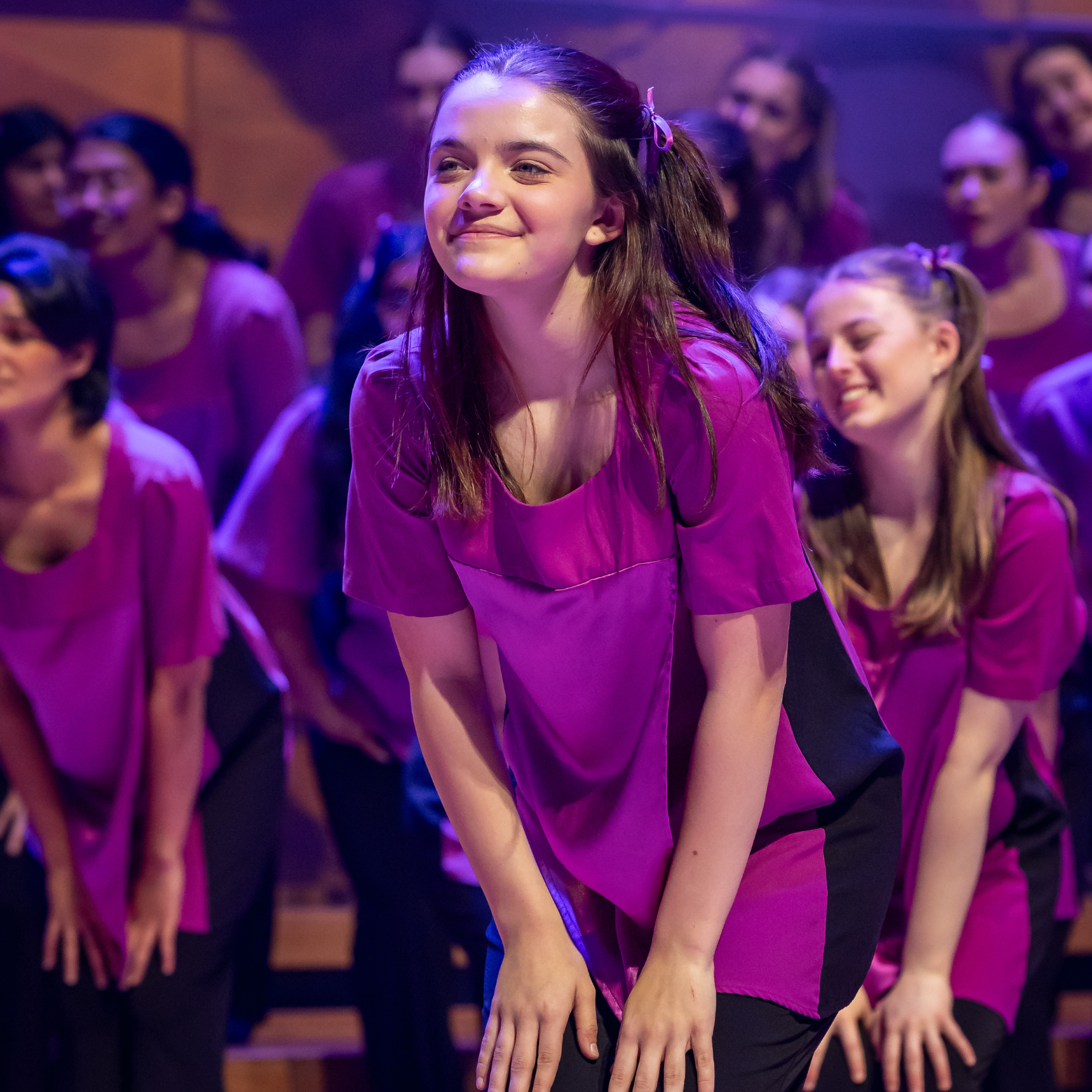 Chorister performs on stage during the AGCC