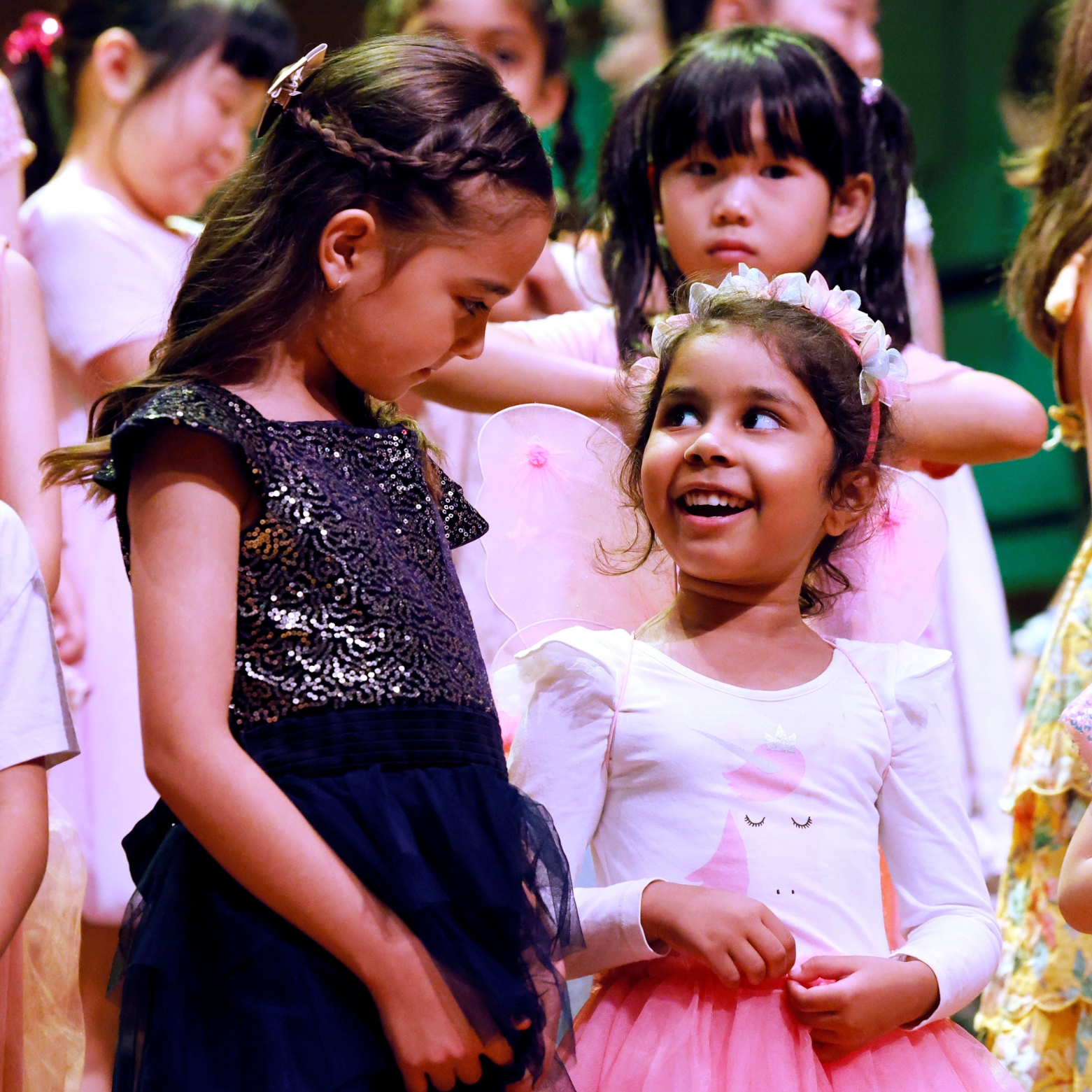 Girls in junior choir on stage in dresses