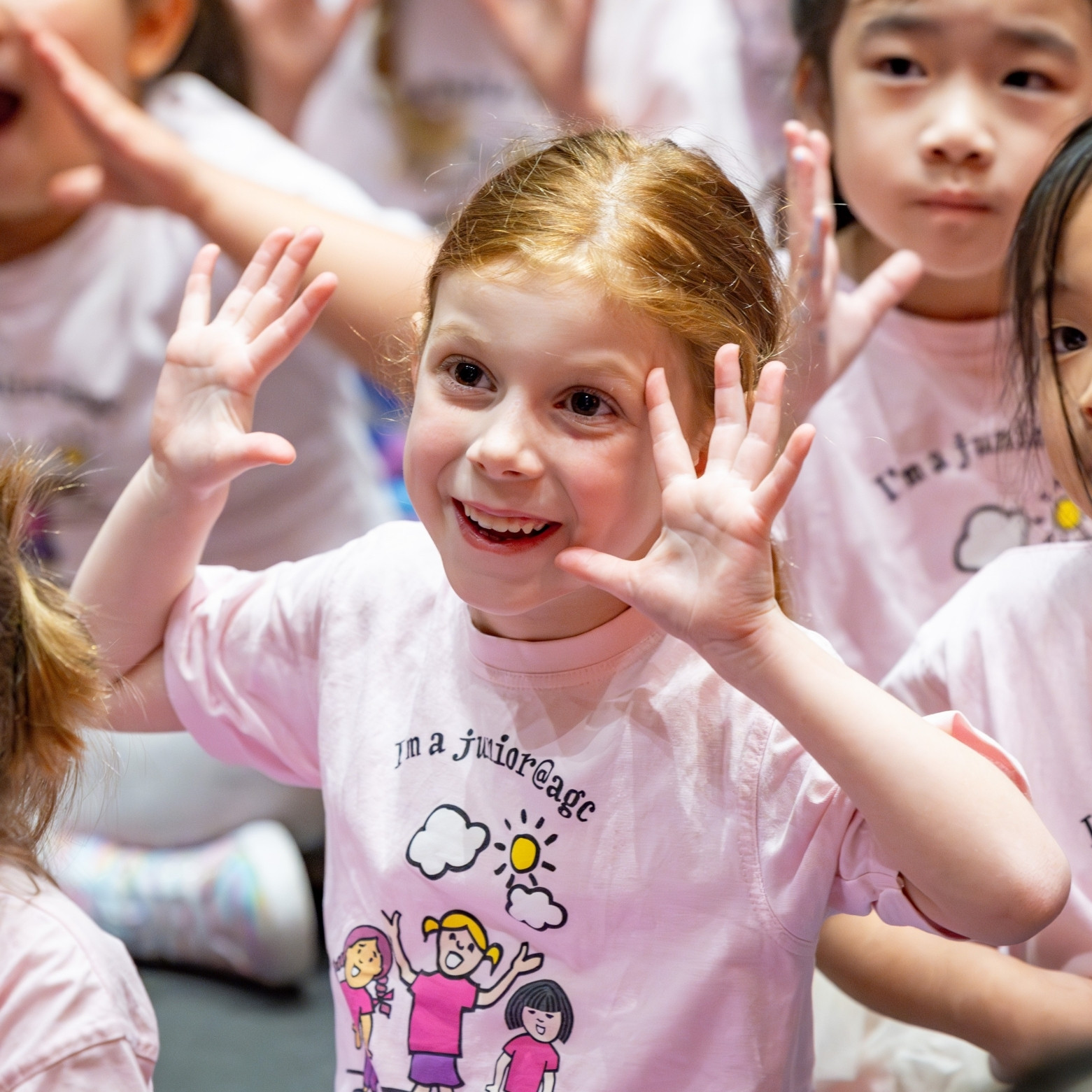 junior AGC choir girl perfroming with hands up in uniform