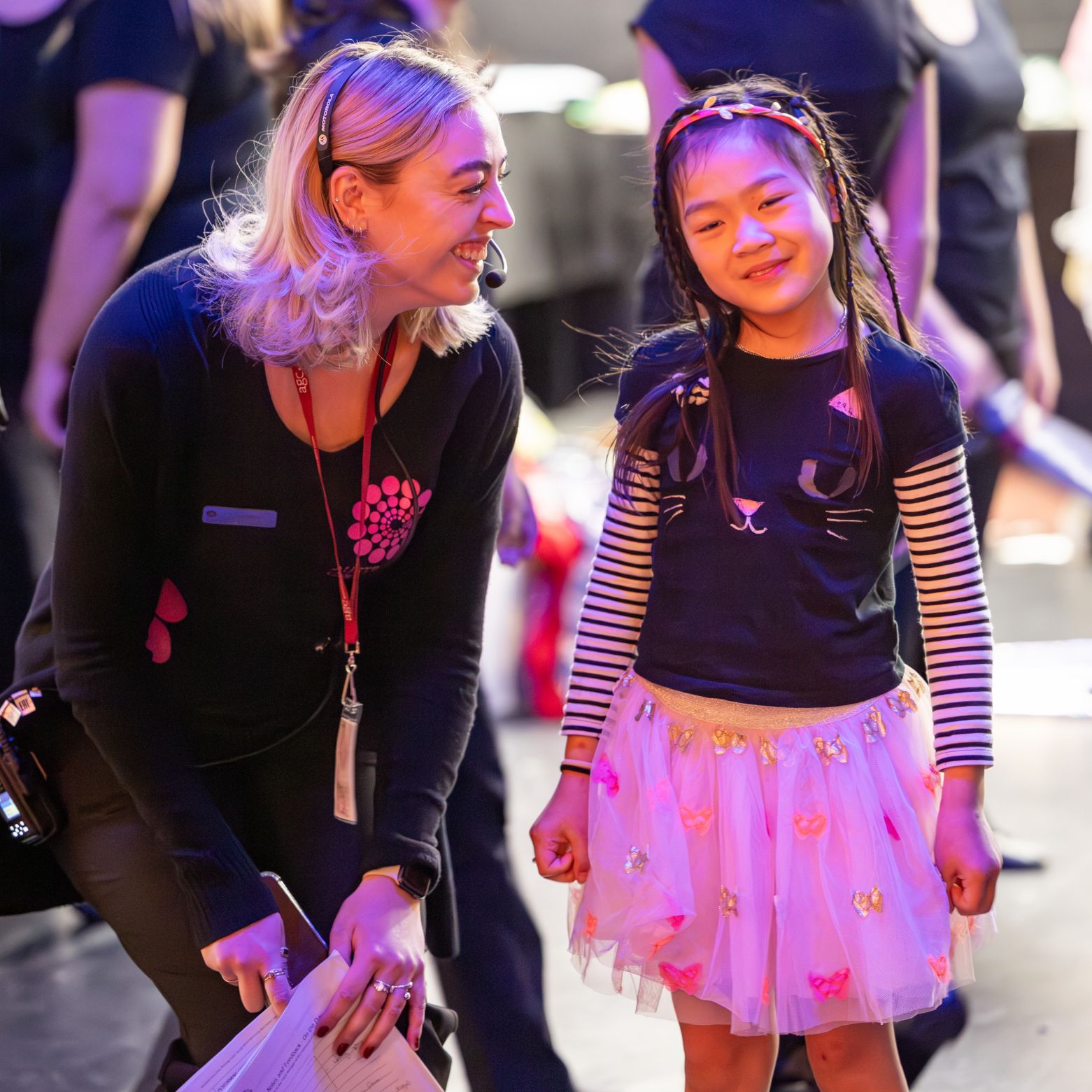 AGC staff member Clare supports a junior@agc chorister side stage